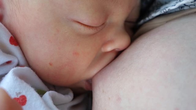 Face Newborn Baby Sleeping Close-up Is Breastfeed