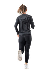 Rear backside view of female runner in hooded sweatshirt running away. Full body length portrait isolated on white background.