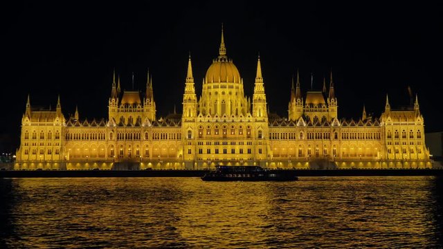 budapest landmark parliament illuminated at night from danube river