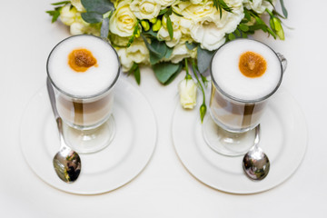 Morning coffee for couple in love. Two cups of cappuccino with latte art on black table.