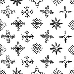 Hand drawn winter seamless patterns with snowflakes