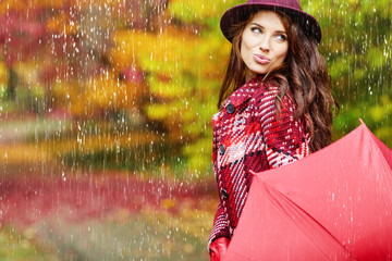 Young woman with autumn leaves and fall yellow maple garden background