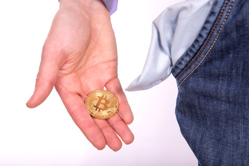 Man holding golden botcoin and showing his empty pocket.