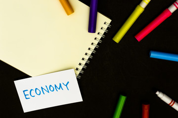 Economy; A Sketchbook and pens on Black Background