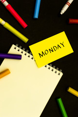 Monday; A Sketchbook and pens on Black Background