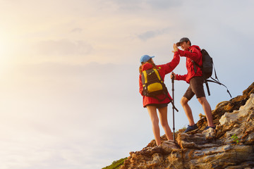 Young asian couple climbing up on the mountain,hiking and team work concept. - 176958874