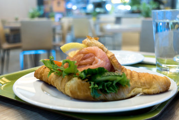 Breakfast with coffee and croissants on table