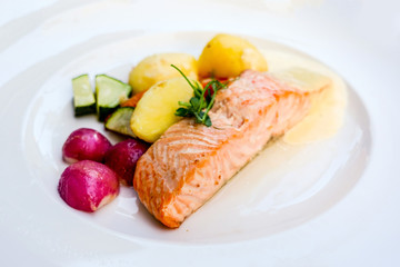 grilled salmon and lemon - french cuisine dish with tomato and salmon