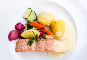 grilled salmon and lemon - french cuisine dish with tomato and salmon
