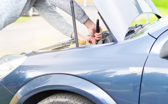 Man Fixing Engine Under The Hood With A Monkey Wrench. Car Repair, Maintenance And Vehicle Inspection Concept.  