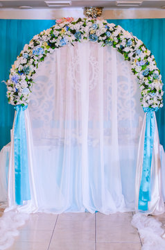 Wedding decor .Arch for carrying out of painting . beautiful wedding feather