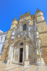 Fototapeta na wymiar Spectacular facade of Santa Cruz Monastery, Praca 8 de Maio, in a sunny day with blue sky. The Church of Santa Cruz is one of the most fascinating religious buildings of Coimbra in Portugal. Vertical.