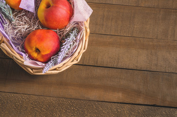 peaches, nectarines in a wicker basket, top view