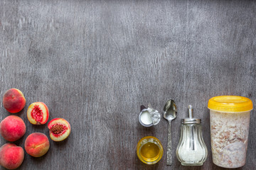Ingredients for oatmeal on dark wooden table. Concept of healthy food. Top view, copy space.