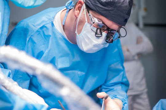 Male dentist performs anesthesia before surgery.