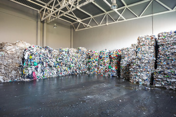 Plastic bales at the waste processing plant. Separate garbage collection. Recycling and storage of waste for further disposal. Business for sorting and processing of waste.