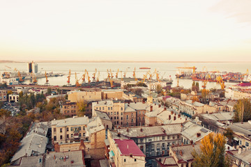 Fototapeta premium aerial view to Odessa, roofs, port and sea at sunset or sunrise 