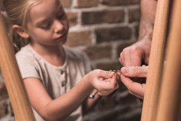 Father and daughter repairing table