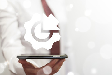 Young business woman using smartphone with arrow gear icon on a virtual interface. Integration...