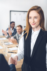 businesswoman shaking hand of partner