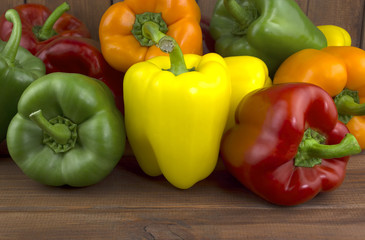 Juicy beautiful Bulgarian pepper on a wooden background