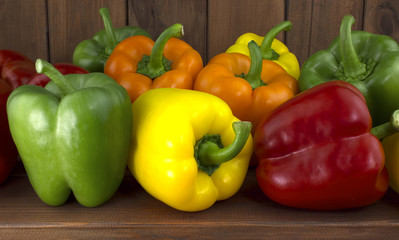 Juicy beautiful Bulgarian pepper on a wooden background