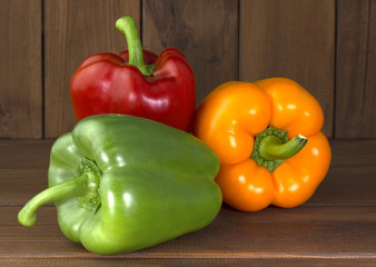 Juicy beautiful Bulgarian pepper on a wooden background
