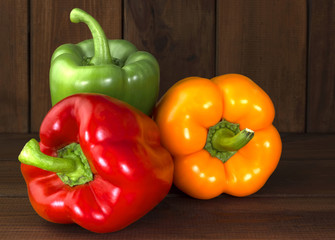 Juicy beautiful Bulgarian pepper on a wooden background