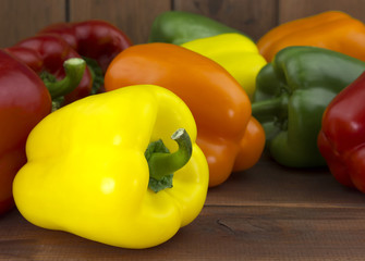 Juicy beautiful Bulgarian pepper on a wooden background