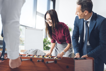 businesspeople playing table football