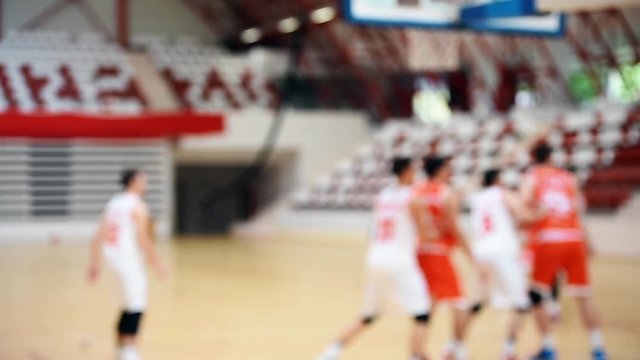 Basketball match scene with players unfocused in the background