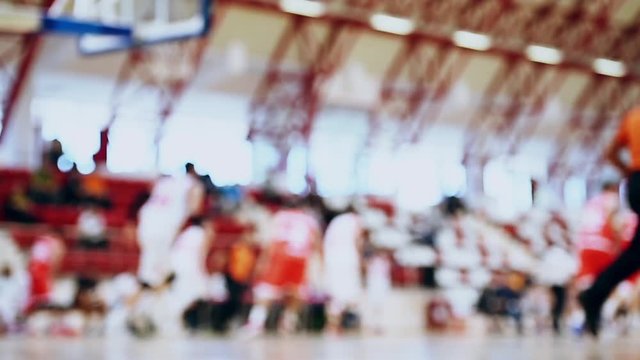 Basketball match scene with players unfocused in the background