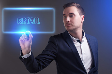 The concept of business, technology, the Internet and the network. Young businessman showing inscription: Retail