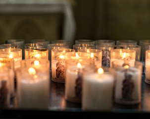 Burning candles at the memorial desk in a church.