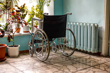 Fototapeta na wymiar Empty wheelchair ready for use near a hospital entrance - Denmark.