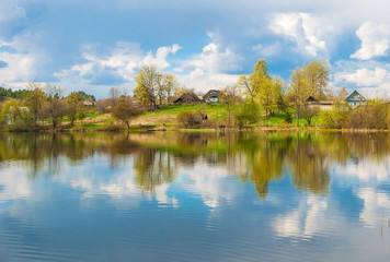 small village on shore of lake in spring