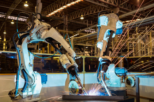 Industrial robot are test run new program in automotive assembly factory