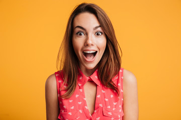 Close up of happy amazed woman with open mouth looking at camera