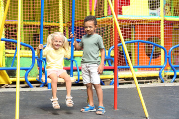 Fototapeta na wymiar Cute girl and boy on playground