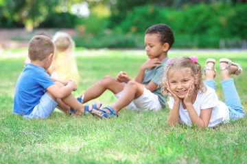 Fototapeta na wymiar Cute little children playing on green grass