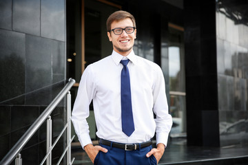 Attractive young man in formal wear on city street