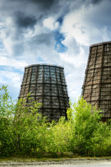 Cooling towers against the background of beautiful mountains and blue sky