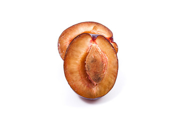 Half of ripe plum isolated on white background..