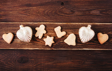 Christmas decoration with gingerbreads,Christmas balls.Wooden background.Holiday,new year  concept.Top view.