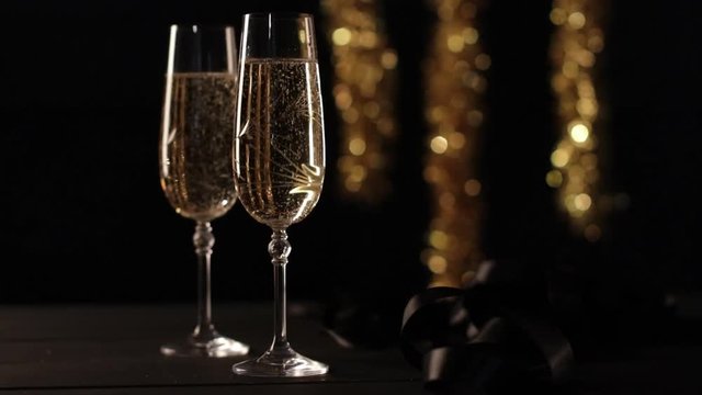 Two champagne glasses with celebration background.