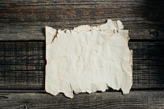 old paper sheet on aged wooden wall