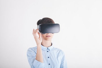 girl in virtual reality headset on white background looking up