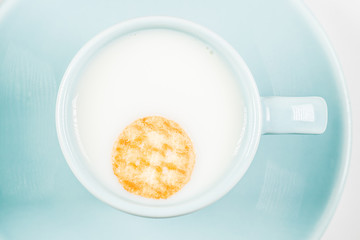 close-up of mug of milk and cookies.