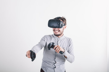 boy in virtual reality headset on white background playing video game