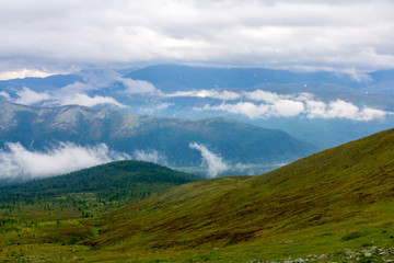 Fototapeta na wymiar Clouds above the mountains and ridges